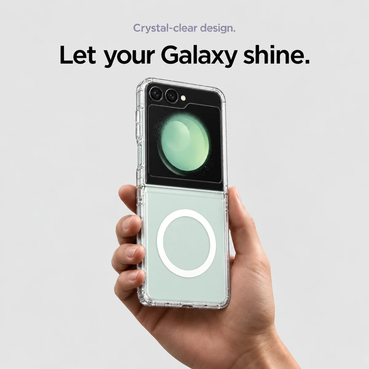 Clear magnetic phone case held at an angle, showing its transparent back and camera openings. #Samsung Model_Samsung Z Flip 5