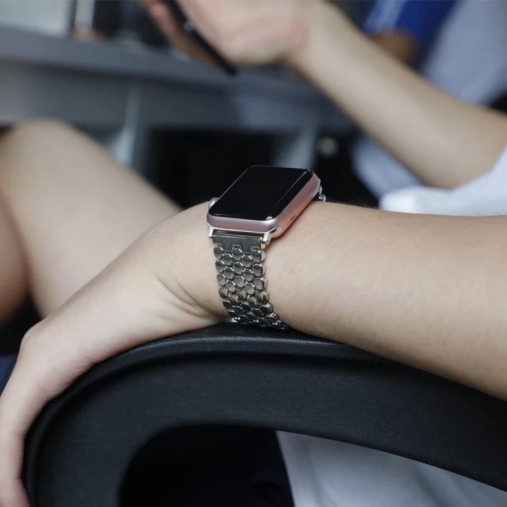 Elegant stainless steel Apple Watch band for women with a polished slim-link design, perfect for formal and casual wear.